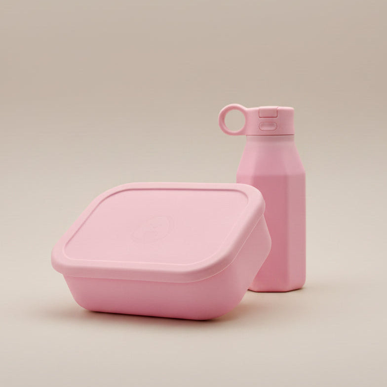 A pink silicone bento lunchbox and water bottle set for kids