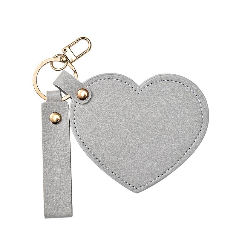 grey Heart-shaped keychain with a strap on a white background
