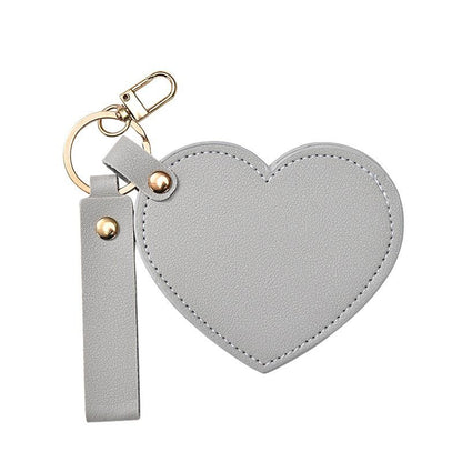 grey Heart-shaped keychain with a strap on a white background