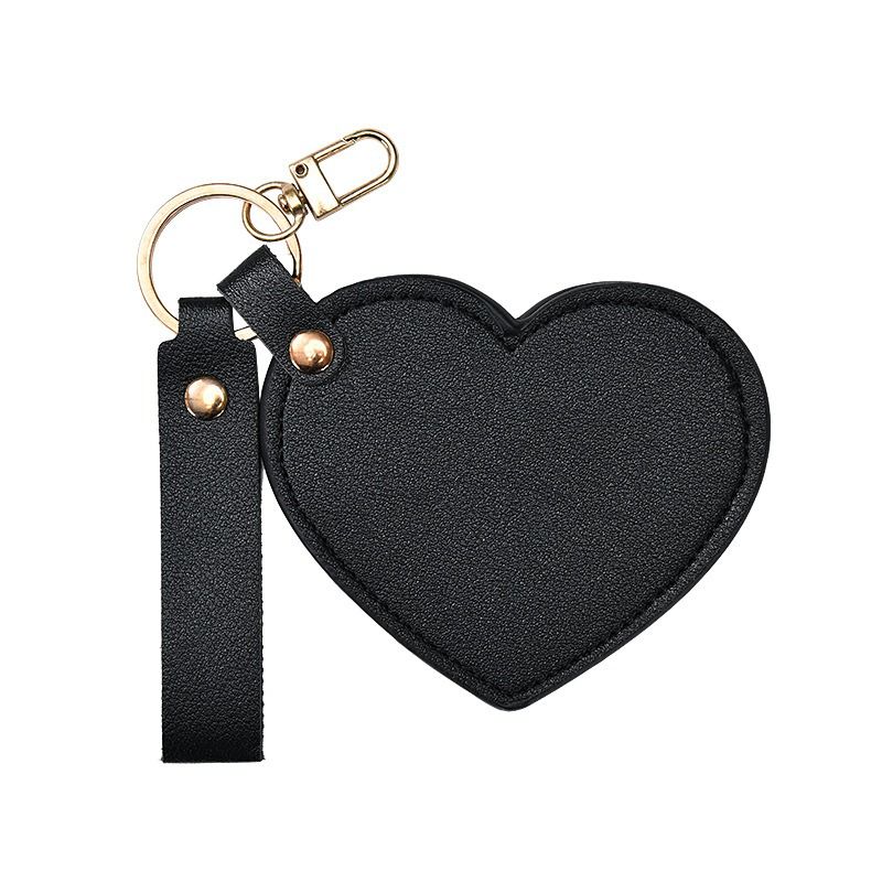 Black heart-shaped keychain with a strap on a white background