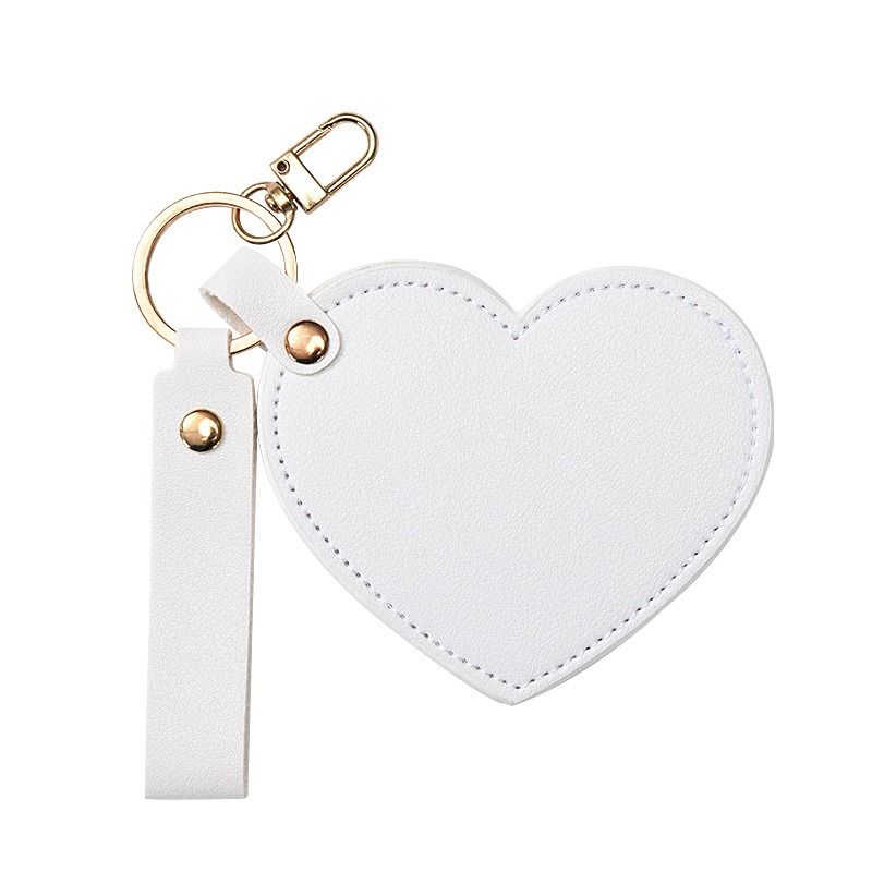 White heart-shaped keychain with a strap on a white background