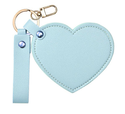 Light blue heart-shaped keychain with strap on a white background