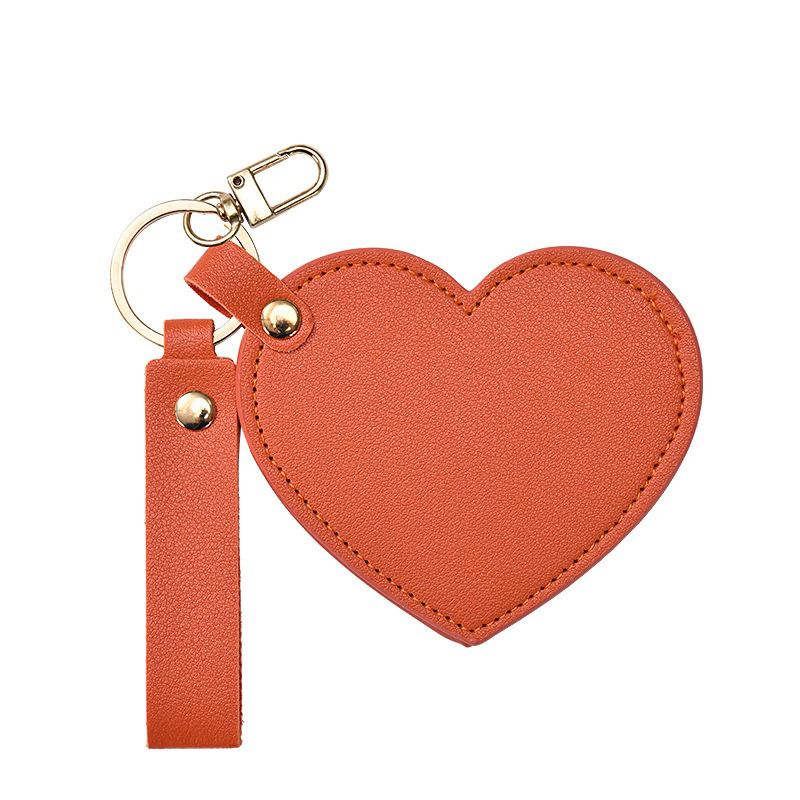sunset orange
Heart-shaped keychain with a strap on a white background