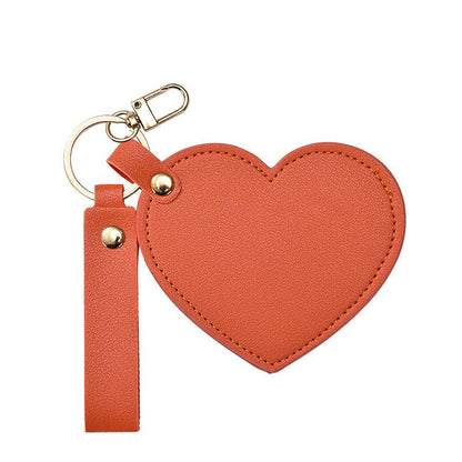 sunset orange
Heart-shaped keychain with a strap on a white background